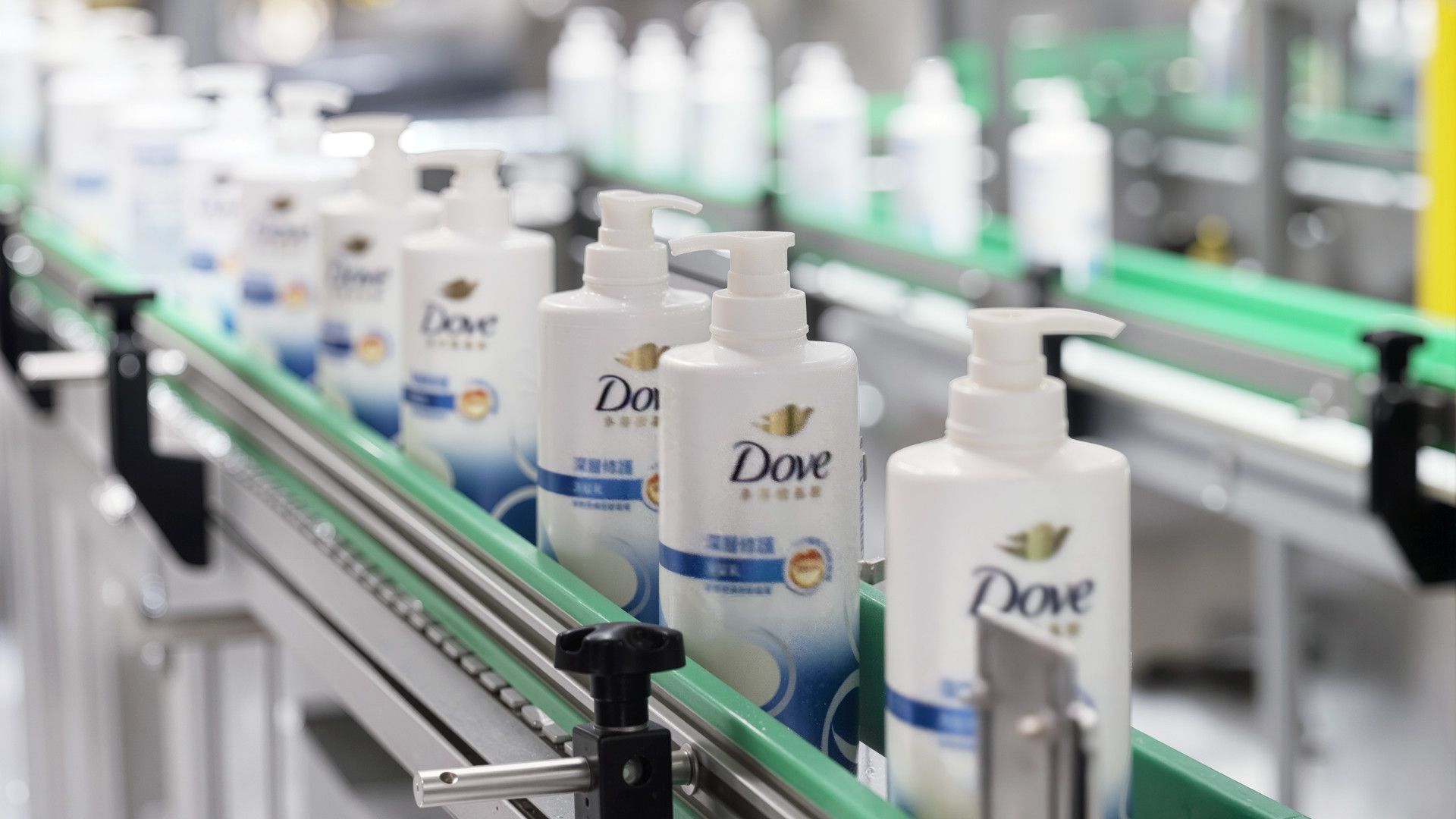 Dove pump action products on a factory production line enabled by AI for efficiency and productivity.