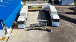 Aerial view of workers and biomethane trucks outside a palm oil facility in Indonesia.