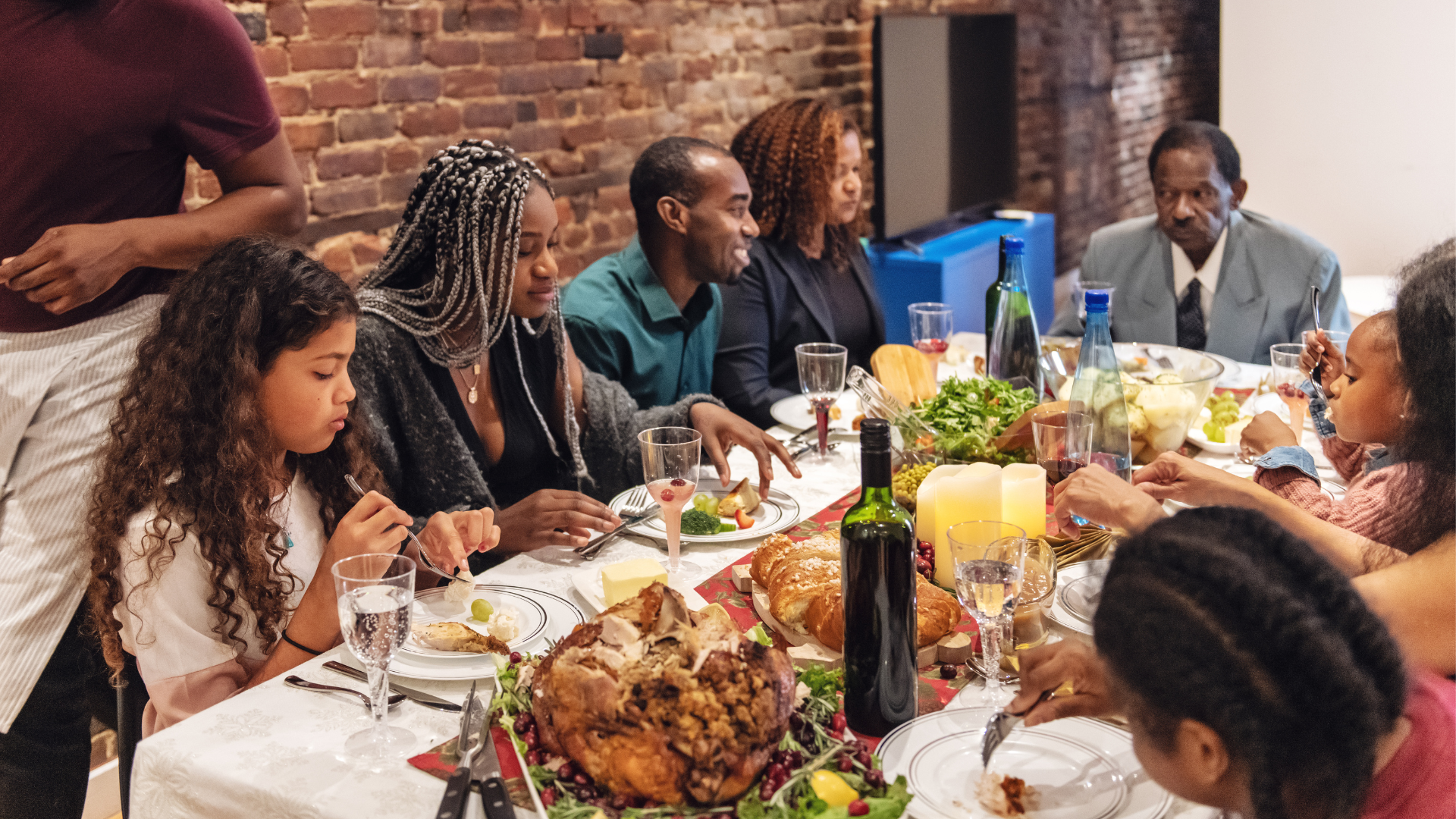 Family gathered around a festive dinner table.