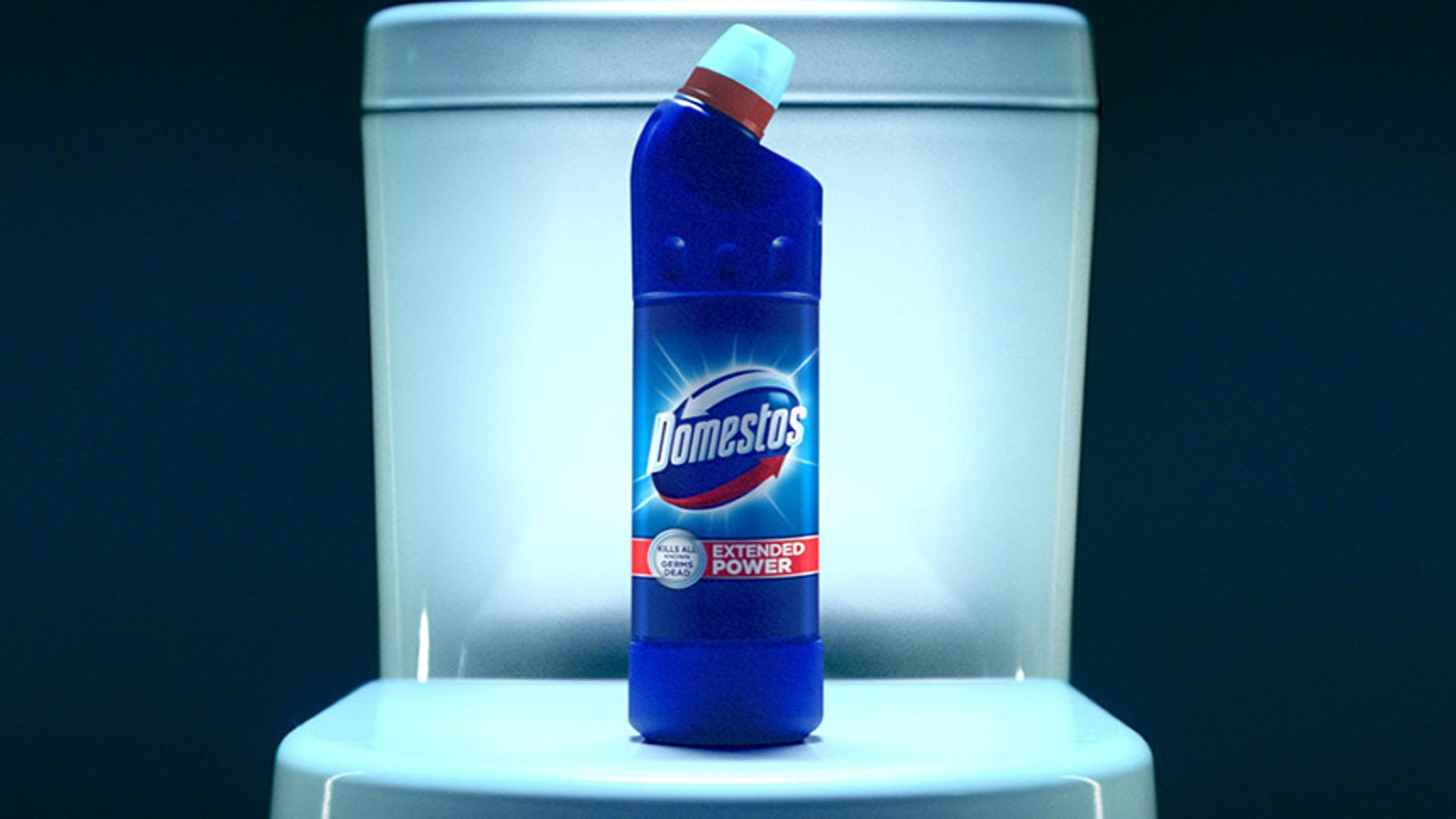 A bottle of blue Domestos on top of a white toilet