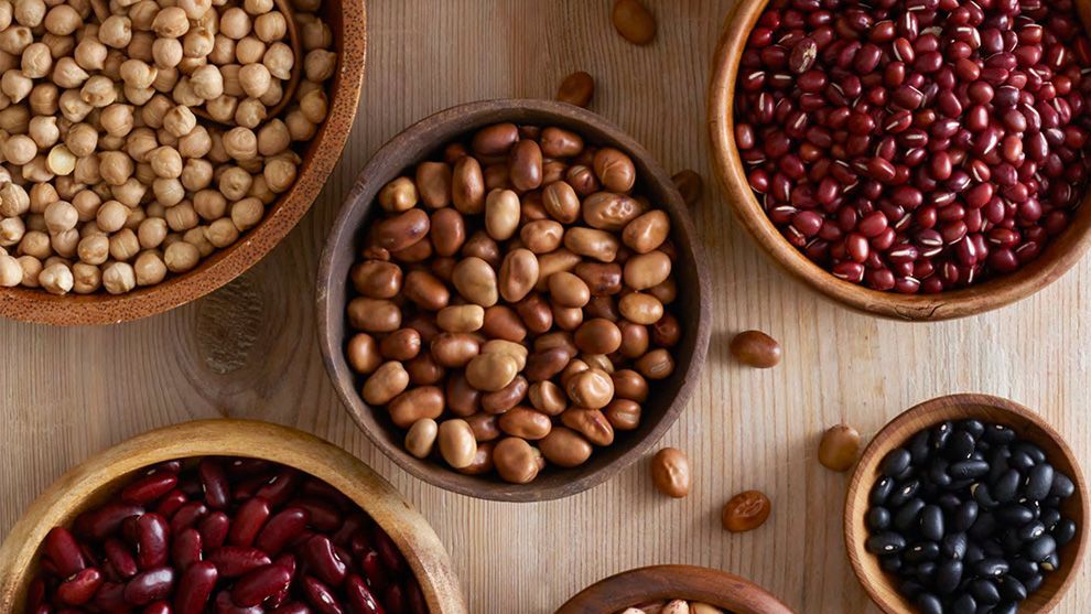 An aerial view of bowls filled with a variety of beans and pulses