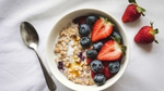 A bowl of oats and red berries.
