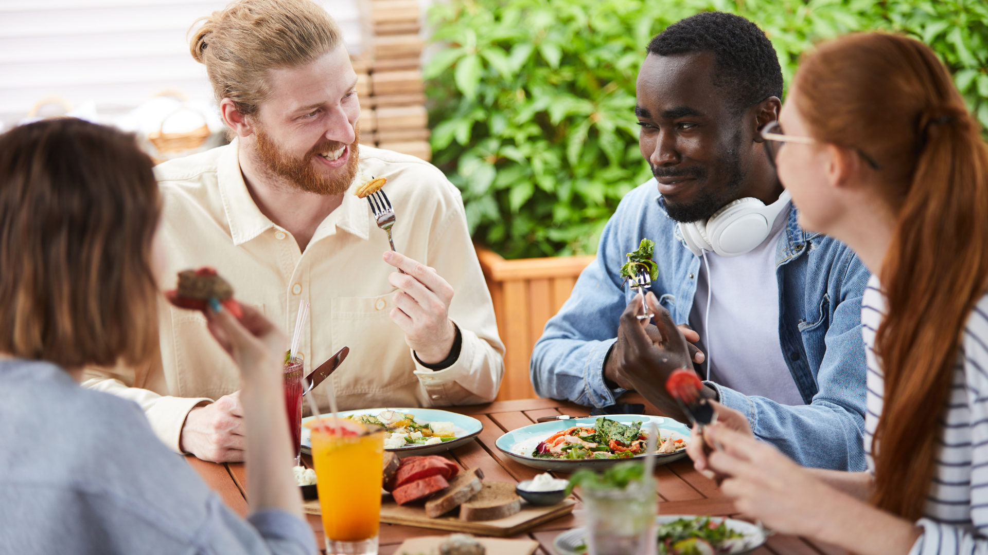 Group of friends enjoying a meal outdoors.