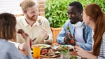 Group of friends enjoying a meal outdoors.