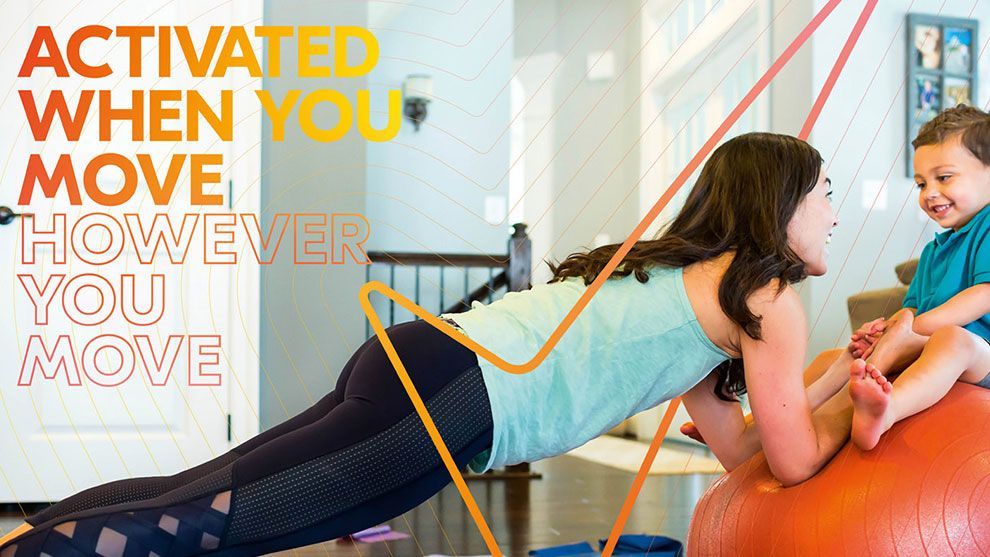 A woman working out at home with her young child