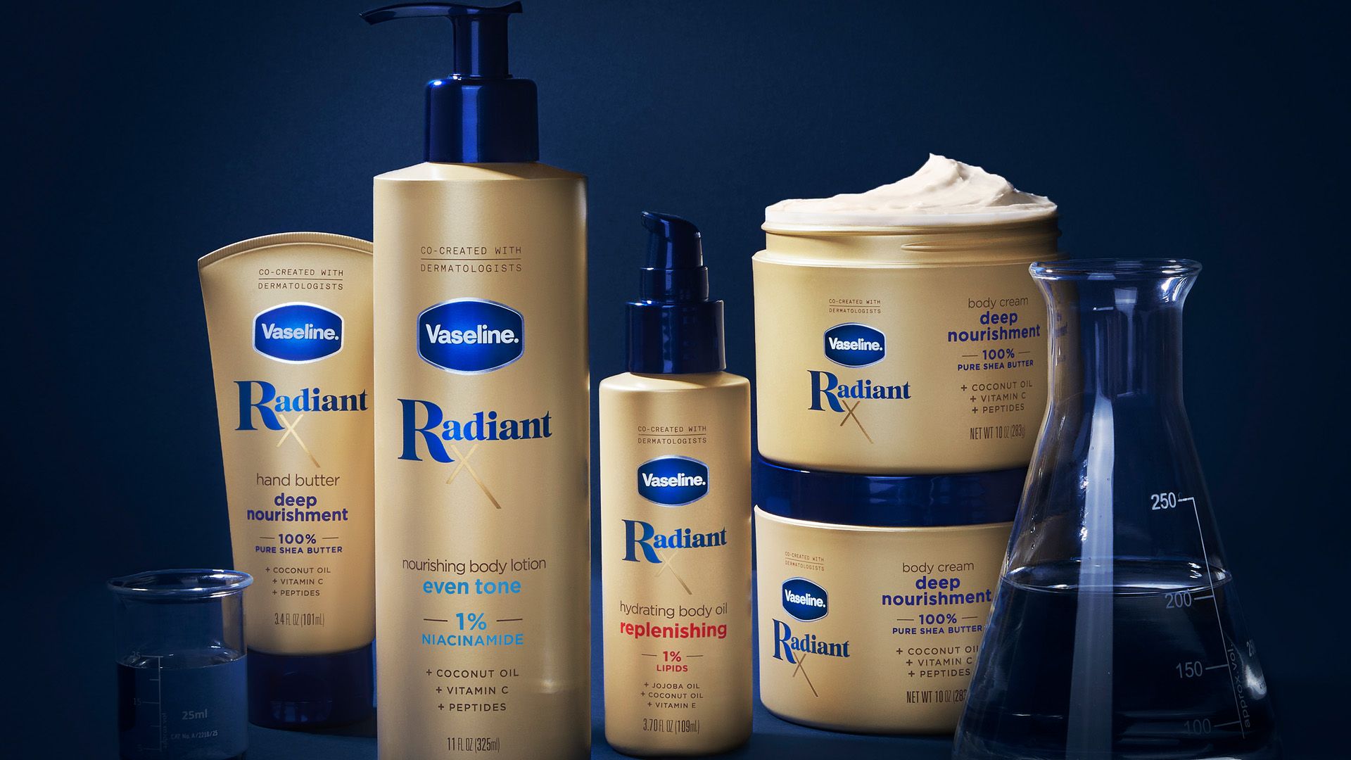 Products from Vaseline’s Radiant X collection, including Nourishing Body Lotion and Hydrating Body Oil. Packaging is golden on a dark blue background.