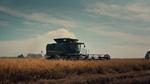 A tractor in a field harvesting crops
