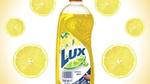 Advert showing a bottle of Lux hand dishwash with a background pattern of slices of lemon.