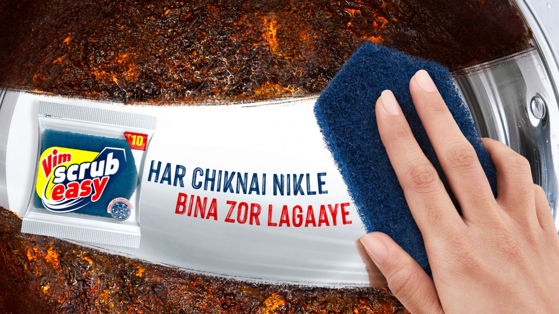 A triangular-ended scrubbing sponge cutting through grease in a pan