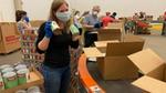 A photo of Unilever employees packing boxes for the United for America initiative