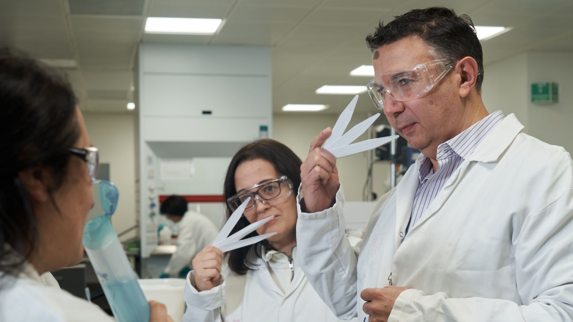 Three scientists (one male, two female) sniffing fragrance testers at Unilever’s Port Sunlight lab.